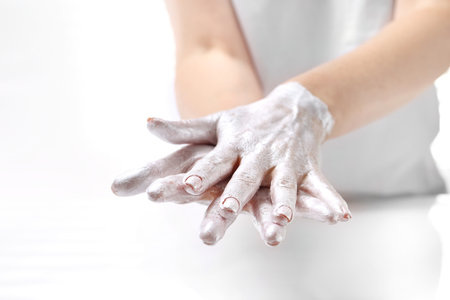 Hand. Beautiful and smooth hand skin. The woman puts a mask on the skin of the hand. Hand skin care.の写真素材