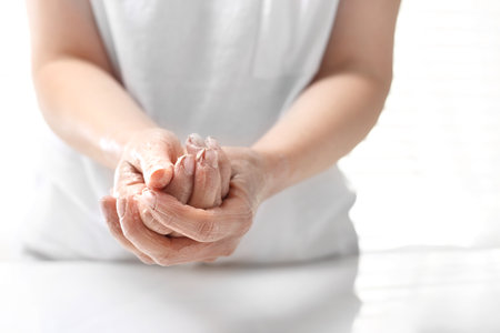 Hand scrub. The woman peels the skin of the handの写真素材