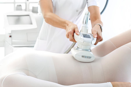 Woman at a cosmetics clinic on body care treatment.の写真素材