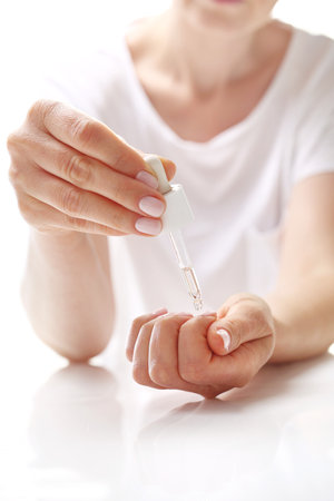 Hand cares, moisturizing nourishing oil for the skin and nails. Home care treatmentsの写真素材