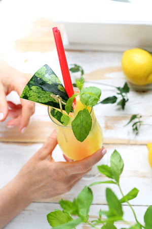 A woman drinking colorful refreshing drinks at the barの写真素材