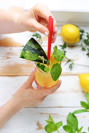 A woman is drinking colorful drinks.の写真素材