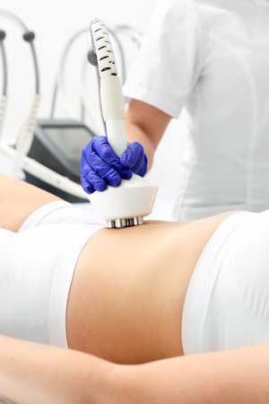 A woman in a cosmetics clinic on a body modeling treatment.の写真素材