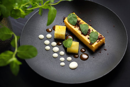 Dessert. A portion of a tasty cake on an elegant black plate. A proposal to serve a dishの写真素材