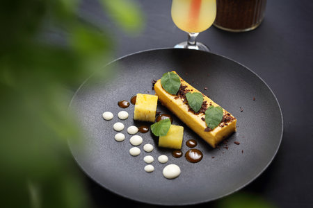 Dessert. A portion of a tasty cake on an elegant black plate. A proposal to serve a dishの写真素材