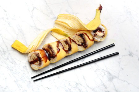 Banana sushi. Sushi roll with strawberry and chocolate.の写真素材