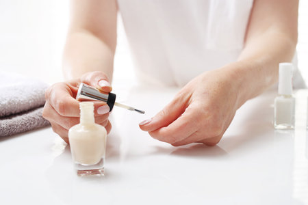Manicure. Painting of nails. The woman is painting her nails.の写真素材