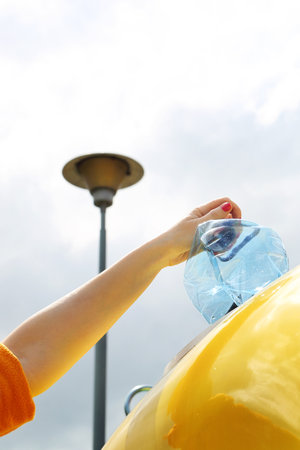 Sorting of waste, segregation of plastic waste into a containerの写真素材