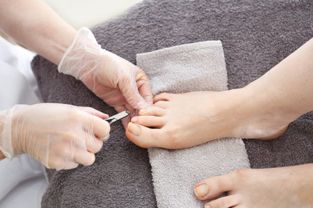 Nail clipping, foot care, female feet during a pedicure at a beauty salon.の写真素材