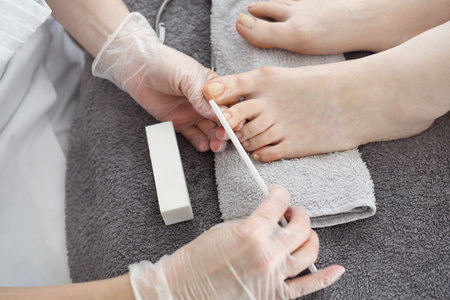 The beautician performs a pedicure treatment.の写真素材