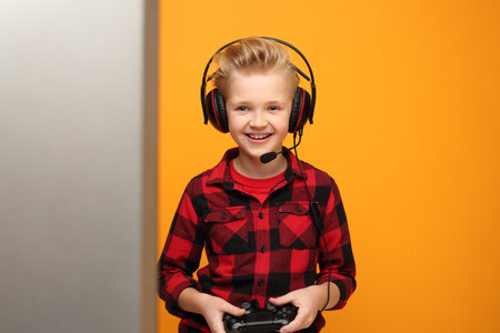 Boy plays video games in headphones.の写真素材
