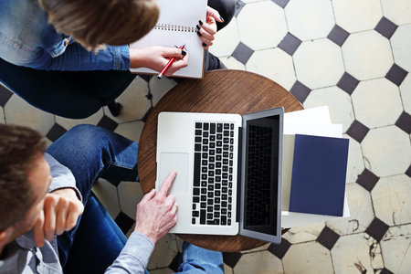 Business meeting. The woman and the man are working together on the computer.