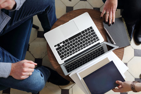 Remote work, people work outside the office. The woman and the man are working together on the...