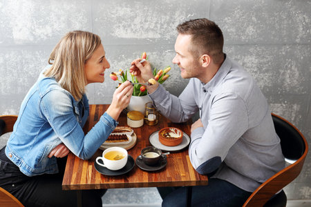 Couple in love on a date in a cafe. Happy young people during meeting in the cafe