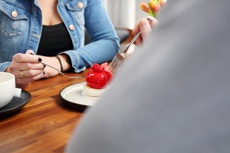 Meeting in a cafe. tasty cookie eaten by a couple in loveの写真素材