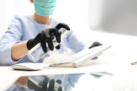 Computer keyboard disinfection. Disinfection of office equipment, protection against viruses.の写真素材