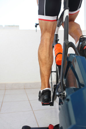 Riding an exercise bike. Sports training on a stationary exercise bike.