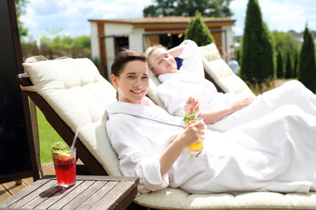 Rest in a holiday resort. Two women are relaxing on sun loungers on a sunny summer dayの写真素材