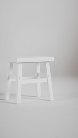 White wooden stool on white background with copy space for your text.