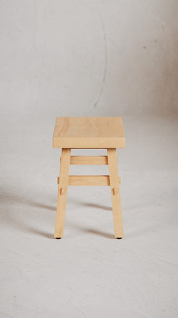 Wooden stool on a white background, close-up image.
