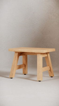 Wooden stool on a gray background. Horizontal photo. Copy space.