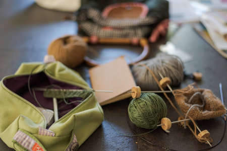Messily creative chaos on table while knitting socks