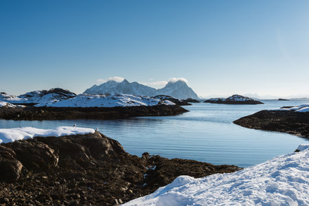 Beautiful winter landscape with sea and steep mountains near Svolvaer on the Lofoten islands in...