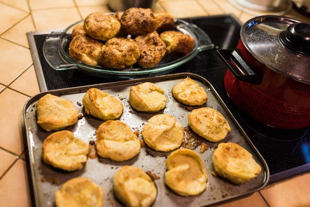 Preparing Yorkshire Puddings in muffin form standing on oven in kitchenの写真素材