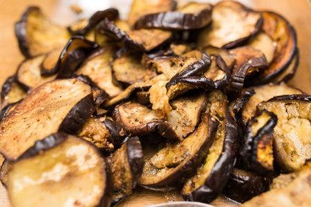 Close up of pile of slices of roasted cooked spicy eggplantの写真素材