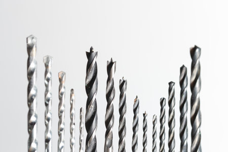 Detail of set of various drills in different sizes for wood, iron and concrete materials collocated together isolated on white backgroundの写真素材