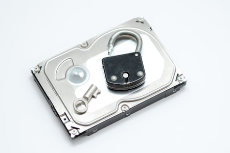 Computer hard disks and open metal padlock symbolizing concept for encrypted data, cyber security on...