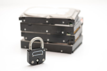 Computer hard disks and metal padlock symbolizing concept for encrypted data, cyber security on...