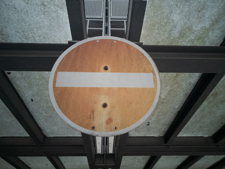 Dirty old run-down traffic sign No Entry on glass roof of public parking garageの写真素材