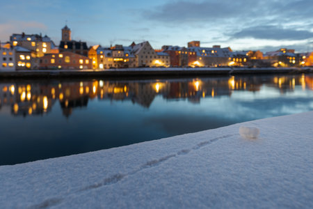 Old town of Regensburg on the danube river in winter with fresh snow and snow ball, focus on foregroundの写真素材