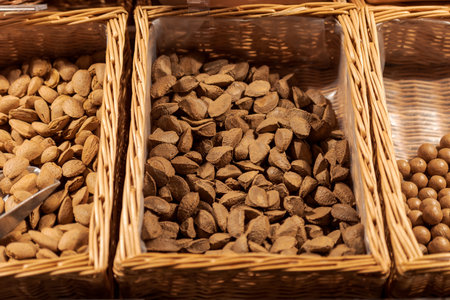 Unpacked Brazil nuts in nutshell in basket on display in organic super market