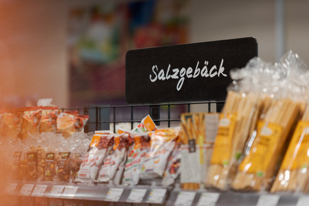 Munich, Germany - 2021 02 05: Sign over shelf in german organic supermarket with german word for salty snacksのeditorial素材