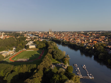 World famous skyline of Regensburg in Bavaria, Germany with cathedral and old town on sunny summer day with marina and sports training groundsの写真素材