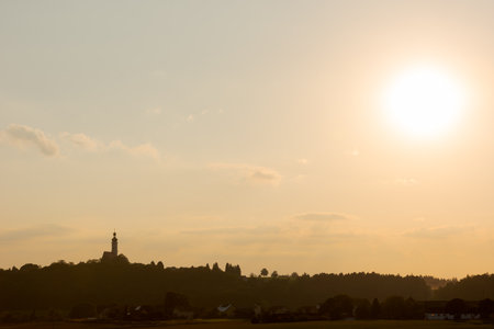 The village Eichlberg near Hemau with church of pilgrimage and surrounding rural area on top of a hill in Bavaria in sunlightの写真素材