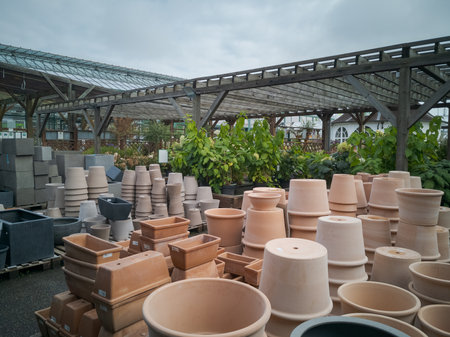 Munich, Germany - 2021 09 27: Terracotta flower pots on display for sale in outdoor area of garden center on cloudy dayのeditorial素材