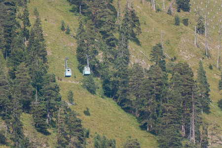 The two cable cars of the Herzogstandbahn in Bavaria passing each other on sunny dayの写真素材