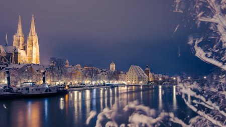 Famous skyline of Regensburg, Bavaria in winter with snow at night during Christmas seasonの写真素材