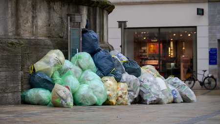 Collection point for disposal of garbage in trash bags on public squareの写真素材