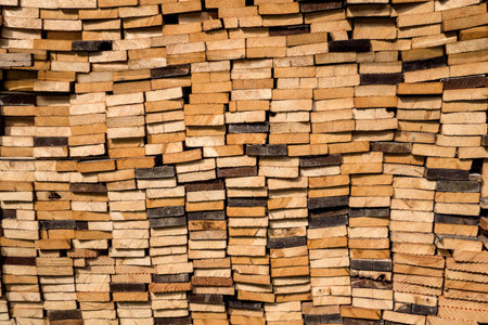 Detail shot of a pile of piled boards in various shades of brown