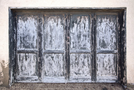 Large weathered wooden door in gray blue anthracite on Lanzarote, Canary Islands, Spain.