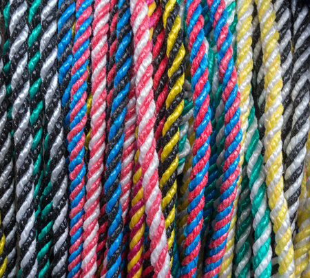 Close-up of multicolored ropes, they hang close next to each other in a rowの写真素材