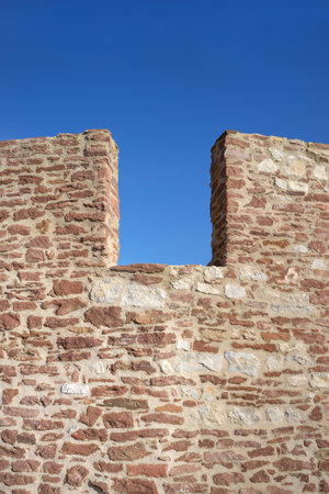 Architectural detail of a castle wall against blue sky