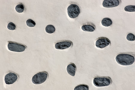 Detail of a Canarian exterior wall, in Which the dark natural stones except a few specimens werewolf covered with white plaster. Taken in La Gomera, Canary Islands, Spain.の写真素材