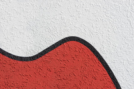 Abstract pattern of white and red roughcast with a wavelike black separator lineの写真素材