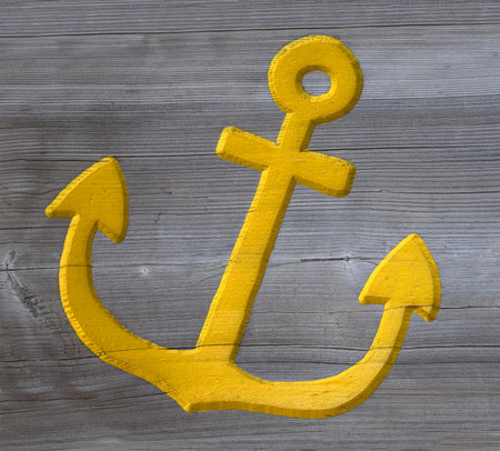 Yellow anchor carved in wood