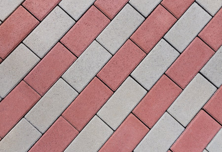 Diagonal pattern of red and gray cobblestonesの写真素材
